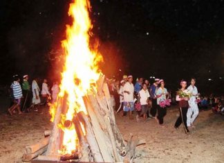 Students circle the campfire during their scouting camp at Sattahip’s Prince Chumphon Military Camp.